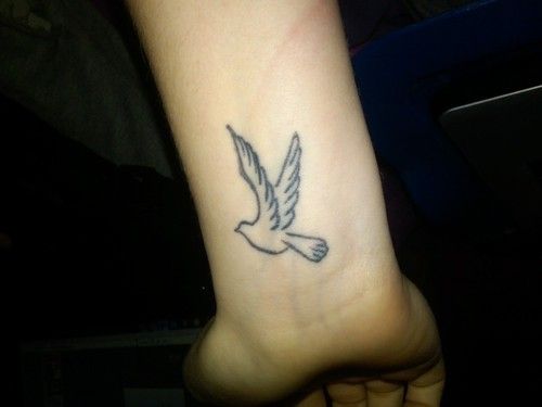 Outline Flying Dove Tattoo On Left Wrist For Girls