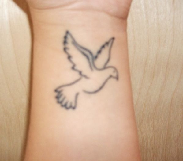 Outline Flying Dove Tattoo On Left Wrist