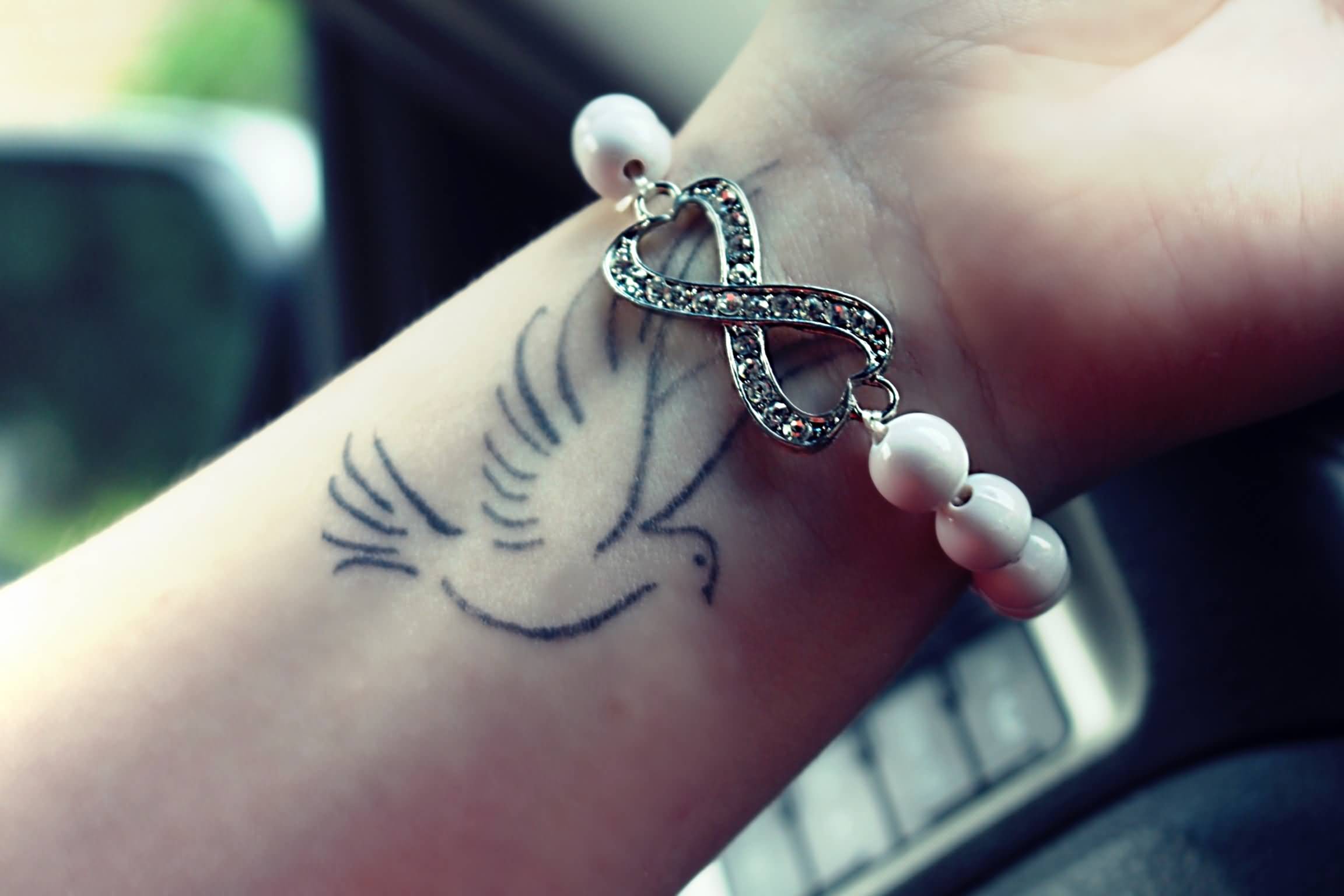 Outline Flying Dove Tattoo On Right Wrist