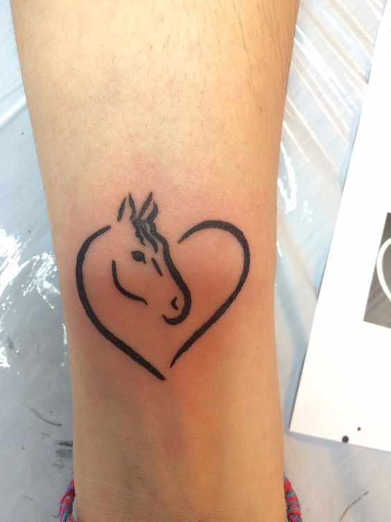Outline Heart And Horse Head Tattoo On Leg