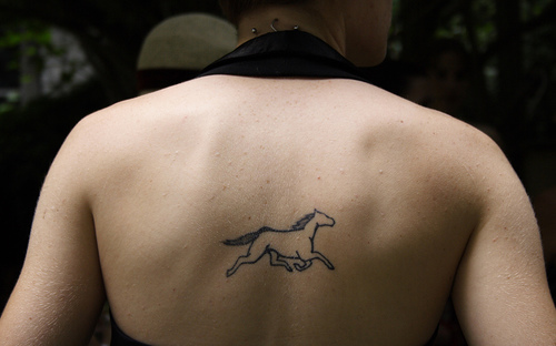 Outline Horse Tattoo On Girl Upper Back