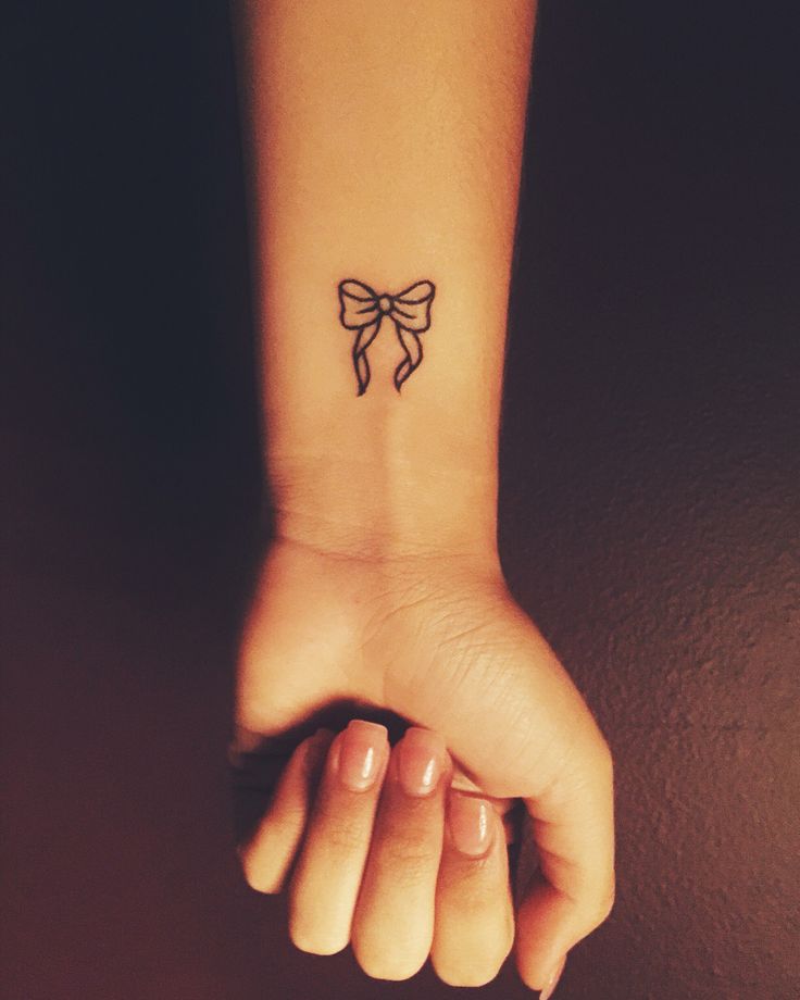 Outline Small Bow Tattoo On Left Wrist