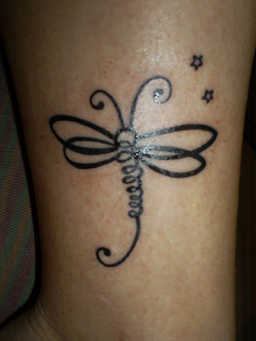 Outline Stars Tribal Dragonfly Tattoo On Arm