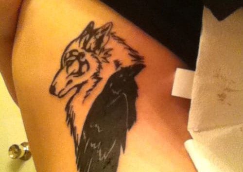 Outline Wolf And Black Raven tattoo On Side Rib
