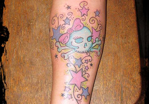 Pink And Blue Stars With Skull Tattoo On Forearm