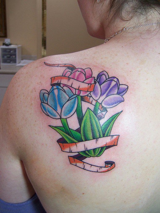 Pink, Blue And Purple Flowers Tattoo On Left Back Shoulder