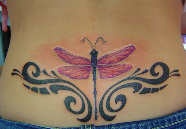 Pink Dragonfly And Tribal Tattoo On Lower Back