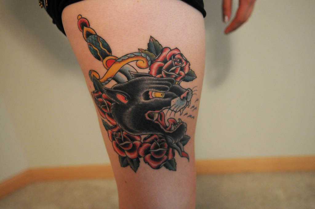 Red And Black Roses With Dagger Head Tattoo On Thigh