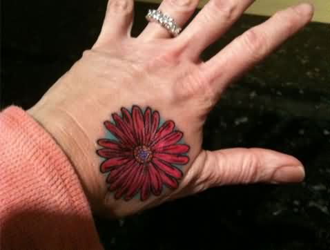 Red Daisy Flower Tattoo On Left Hand
