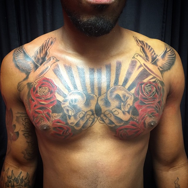 Red Roses And Praying Hands With Flying Peace Dove Tattoos On Man Chest