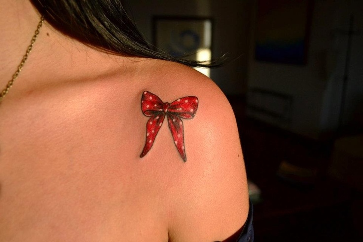 Red Small Bow Tattoo On Girl Front Shoulder