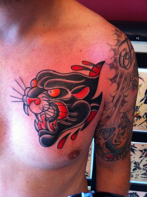 Ripped Skin Black Panther Head Tattoo On Chest