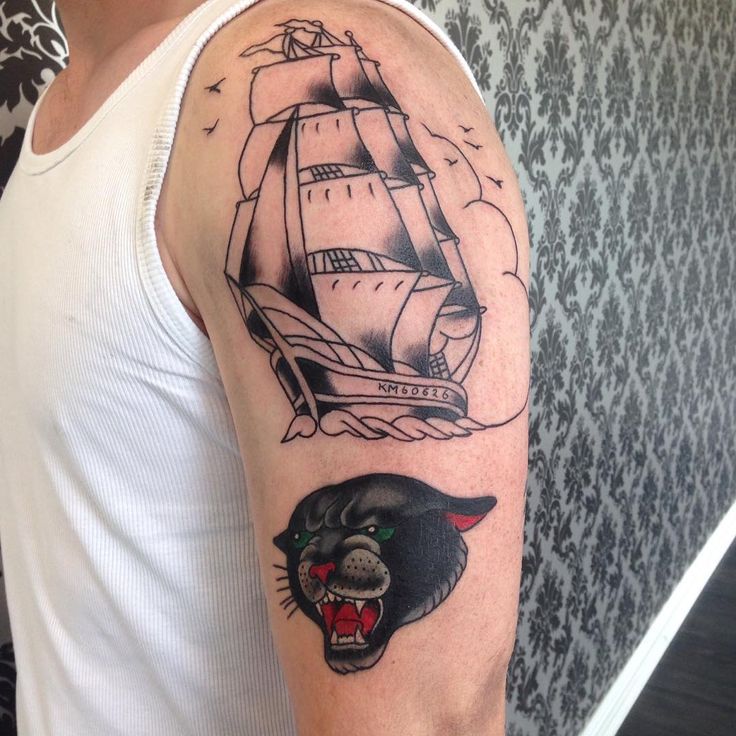 Ship And Panther Head Tattoo On Man Left Half Sleeve