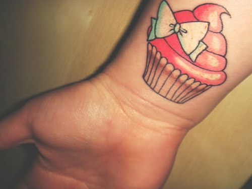 Simple Bow Cupcake Tattoo On Right Wrist