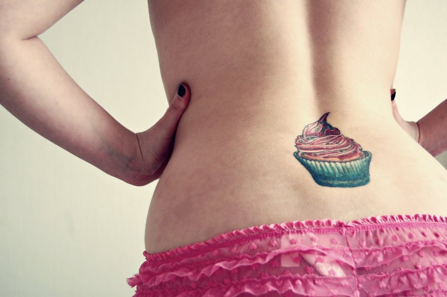 Simple Cupcake Tattoo On Girl Lower Back.