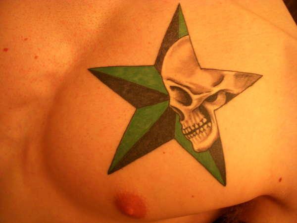 Skull And Green Nautical Star Tattoo On Man Chest
