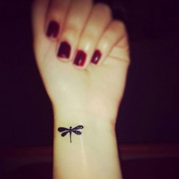 Small Black Dragonfly Tattoo On Girl Left Wrist