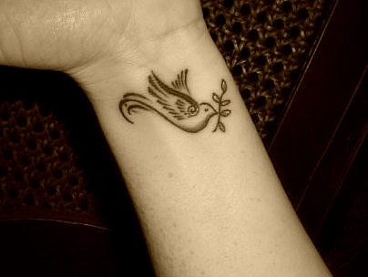Small Black Ink Dove Tattoo On Left Wrist