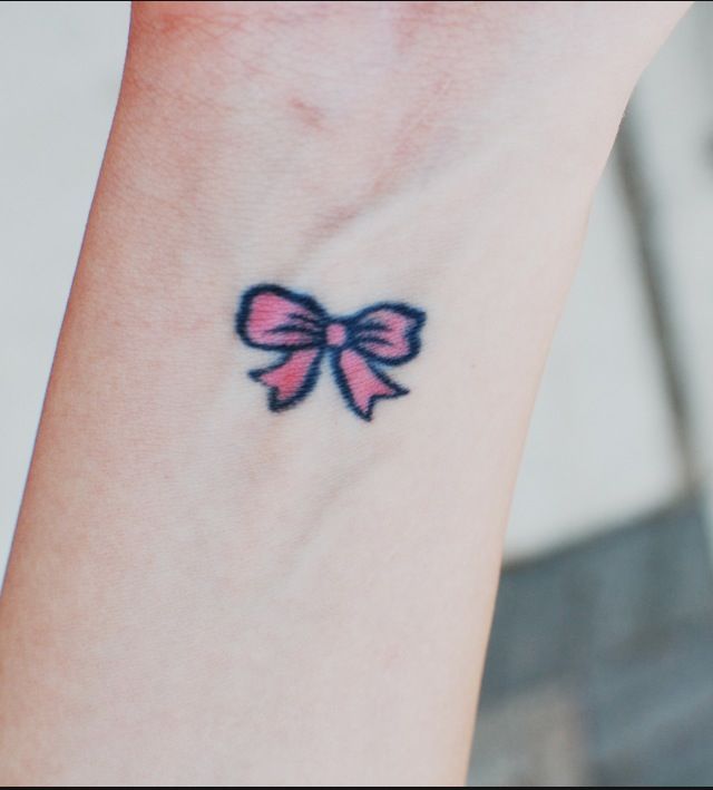 Small Pink Bow Tattoo On Wrist