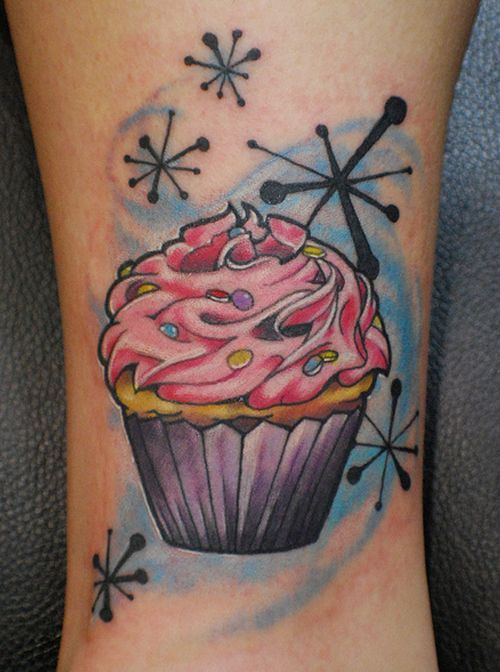 Snow Flakes And Cupcake Tattoo On Leg
