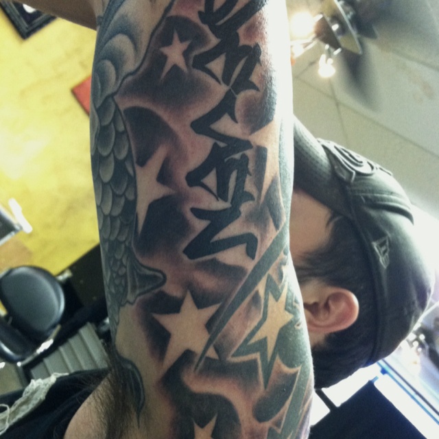 Stars and Clouds Tattoo On Man Left Sleeve