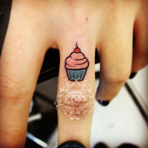 Tiny Cupcake Tattoo On Girl Middle Finger