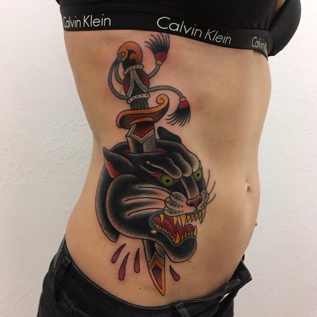 Traditional Panther Head With Dagger Tattoo On Side Rib