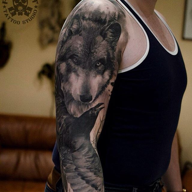Wolf And Raven Tattoo On Man Right Sleeve
