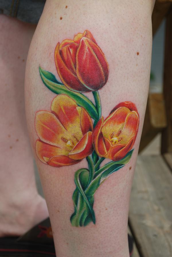 Yellow And Orange Ink Tulip Flowers Tattoos on Side Leg