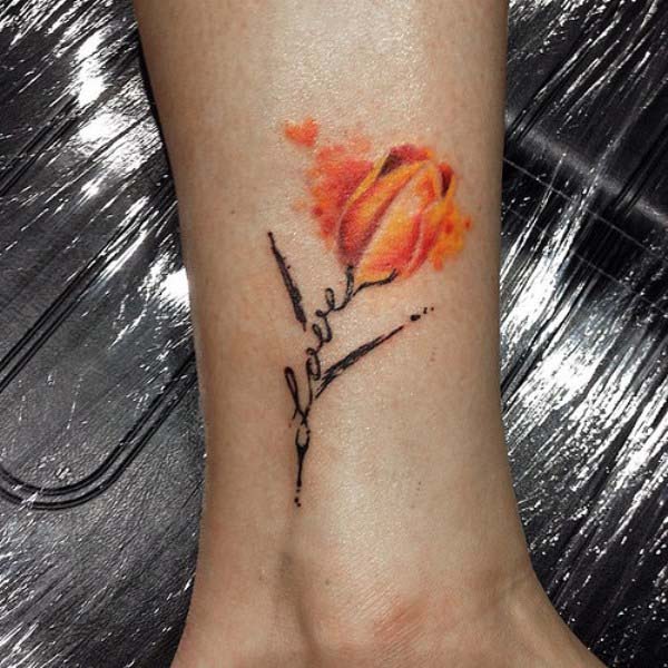 Yellow And Orange Tulip Flower Tattoo On Side Leg