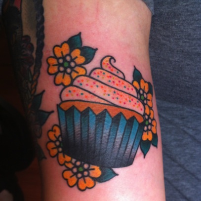 Yellow Flowers and Cupcake Tattoo On Bicep