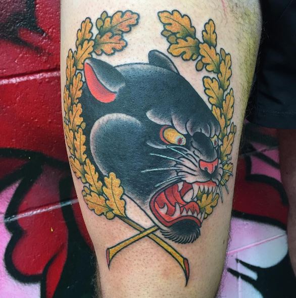 Yellow Leaves And Angry Panther Head Tattoo On Leg