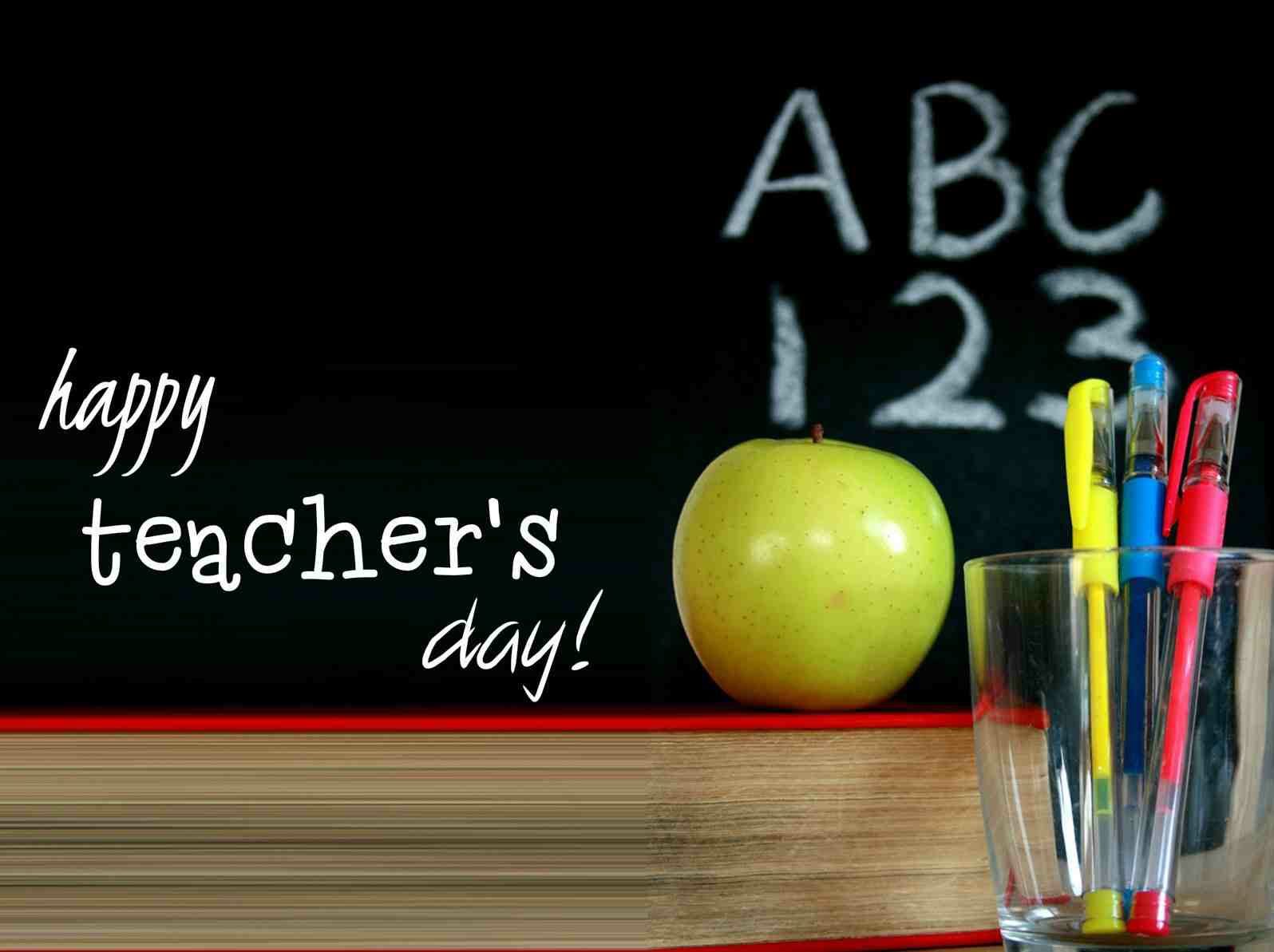 Happy World Teachers’ Day  Apple On Book And Pens