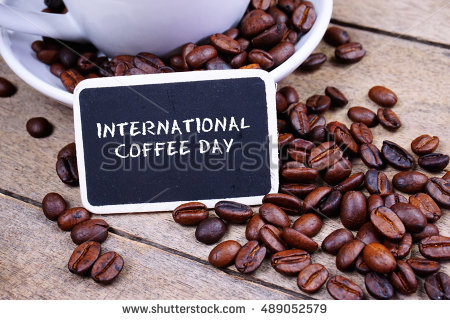 International Coffee Day Written On Black Board With Coffee Beans