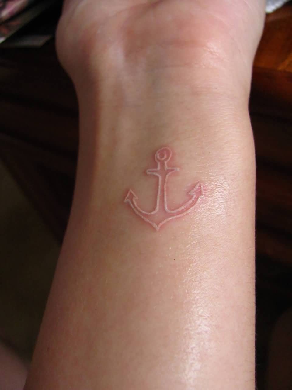 Amazing white Ink Anchor tattoo On Wrist