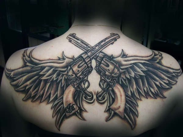 Angel Wings And Pistols Tattoo On Girls Back