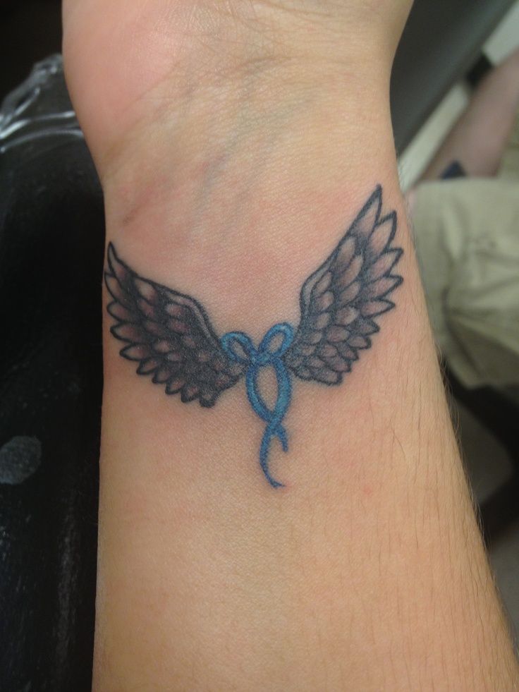 Angel Wings With blue Knot Tattoo On Wrist