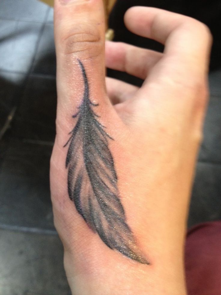 Black And Gray Feather Tattoo On Hand Thumb