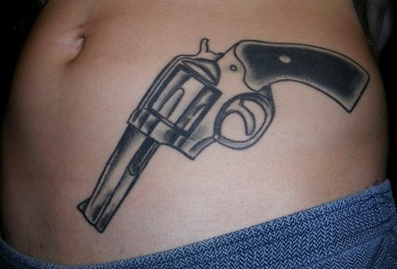 Black And Gray Pistol Tattoo On Hip