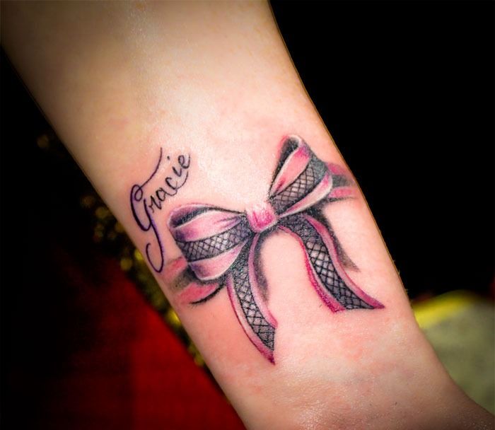 Black And Pink Bow Tattoo On Leg