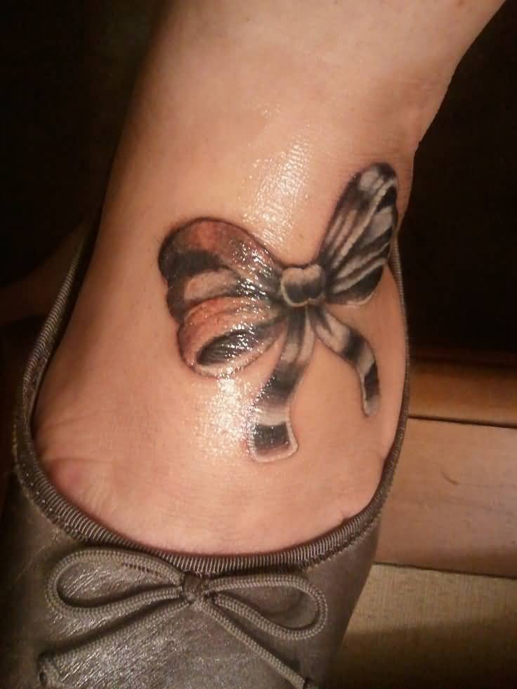 Black And White Bow Tattoo On Foot