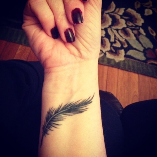 Black Feather Tattoo On Girls Wrist