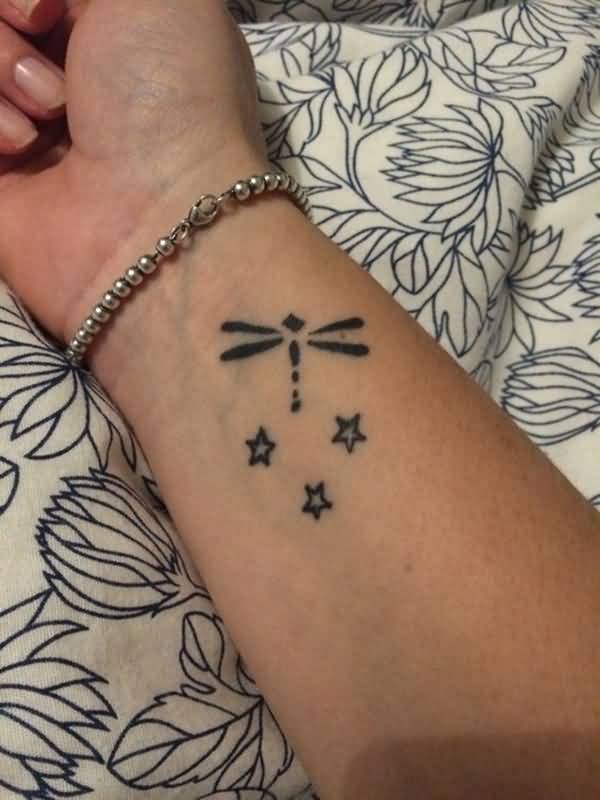 Black Ink Dragonfly And Stars Tattoo On Wrist