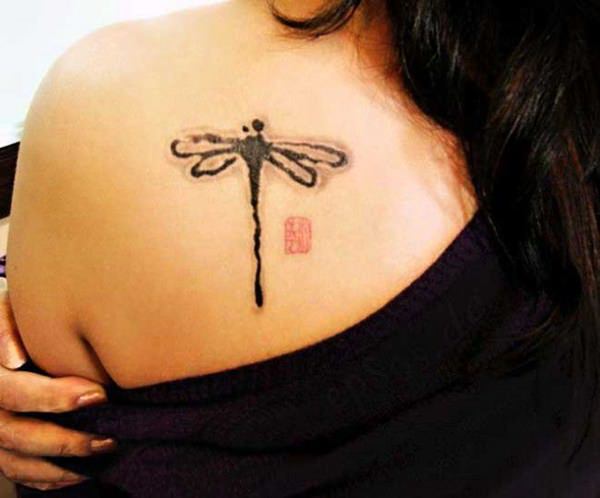 Black Ink Freehand Dragonfly Tattoo On Girls Back