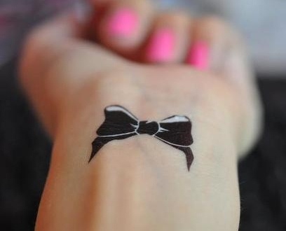 Black Small Bow Tattoo On Wrist