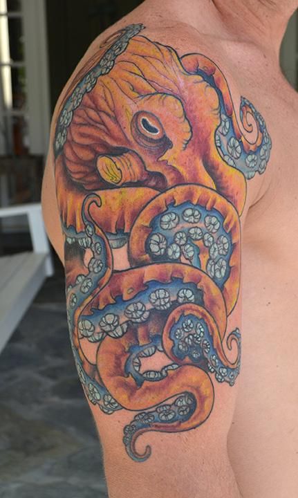 Blue And Orange Octopus Tattoo On bicep
