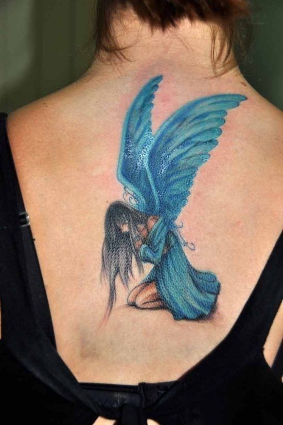 Blue Dressed Sad Angel Tattoo On Girls Back
