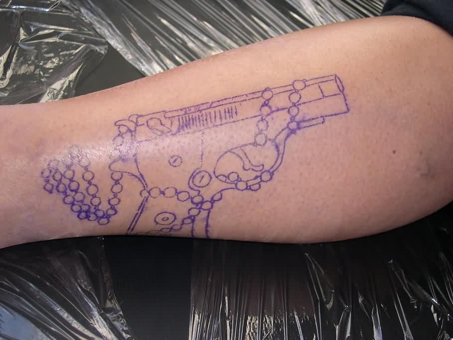 Blue Ink Outline Rosary And Pistol Tattoo On leg