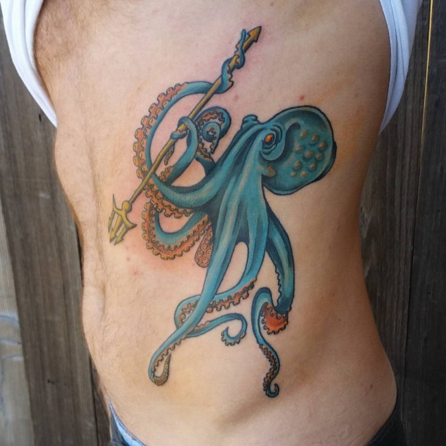 Blue Octopus Tattoo With Trident Tattoo On Side Rib cage