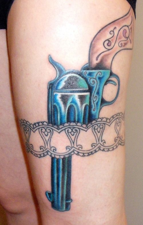 Blue Pistol In Band Tattoo On Thigh